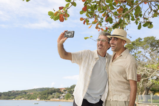 Gay couple taking a selfie with mobile phone