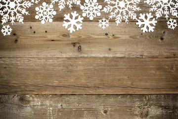 Wooden Christmas background with shiny snowflake top border