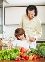 woman and handsome husband cooking together