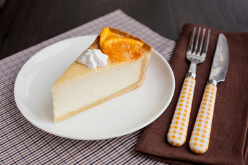 Cheesecake Dessert decorated with oranges and meringue