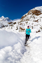 Fototapeta na wymiar Happy woman cross country running in winter
