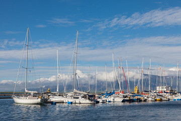 Yachts near the pier on the background of mountains