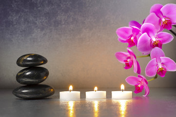 Japanese ZEN garden with stones, candle lights and orchid flower