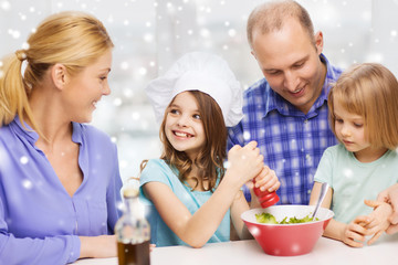 Obraz na płótnie Canvas happy family with two kids making salad at home