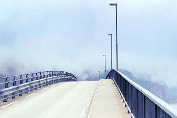 Obraz premium Open road.The bridge in fog
