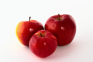 Three fresh red apples isolated on white.