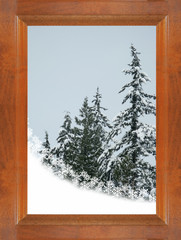 snow snowflakes and snowy trees through a wooden window