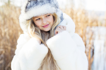 Cute little girl in winter clothes outdoors