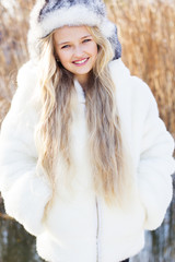 Cute little girl in winter clothes outdoors