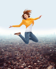 Fototapeta na wymiar smiling young woman jumping high in air