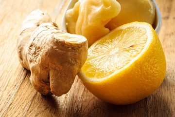 ginger root, honey and lemon on wooden rustic table.
