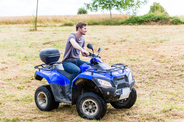 Man driving off-road with quad bike or ATV