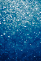 abstract blue background with bokeh particles