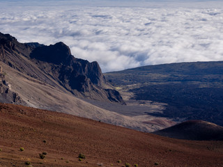 Haleakala volcanic crater with clouds drifting below