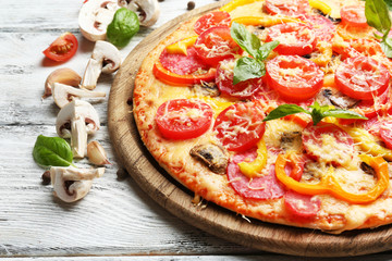 Delicious pizza served on wooden table