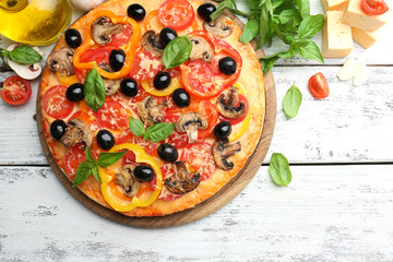 Delicious pizza served on wooden table