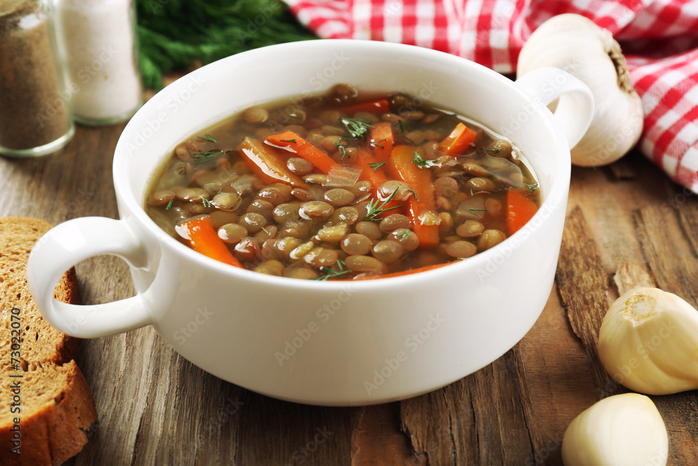 Wall mural delicious lentil soup on table close-up