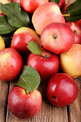Ripe red apples on wooden background