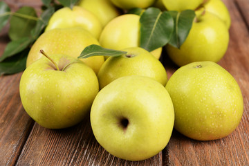 Ripe green apples on wooden background