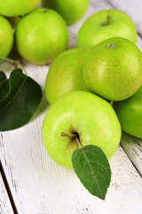 Ripe green apples on wooden background