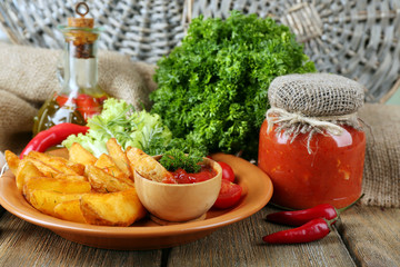 Homemade fried potato on plate on wooden background