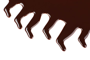 Melted chocolate dripping on white background