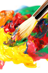 Obraz premium Paint brush with colorful paints, close up