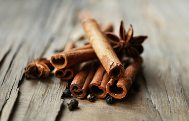 Cinnamon on wooden background, close-up