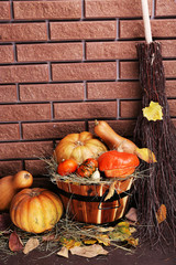 Pumpkins in wooden tub on floor on brick wall background