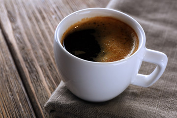Cup of coffee on wooden table