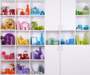 White shelves with colorful things in room
