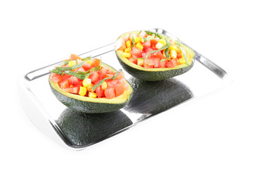 Tasty salad in avocado on tray isolated on white