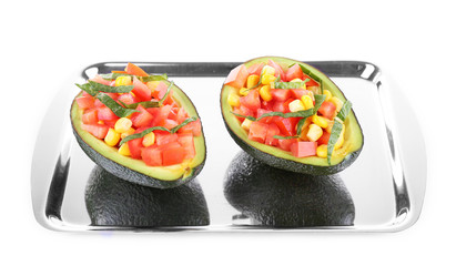 Tasty salad in avocado on tray isolated on white