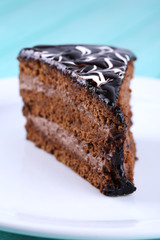Delicious chocolate cake on plate on table close-up