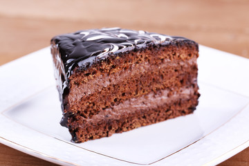 Delicious chocolate cake on plate on table close-up