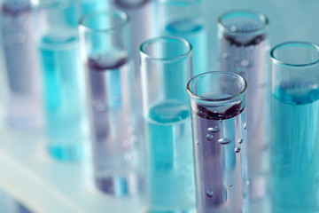 Test-tubes with liquid on color background