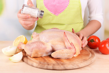 Woman preparing chicken, close-up