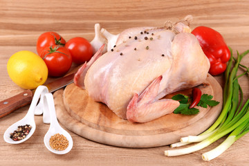 Raw chicken on wooden table