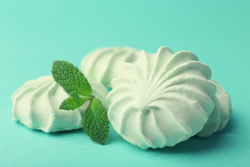 Mint color meringues on color background