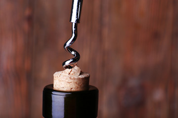 Bottle opener close-up, on wooden background