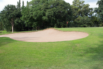 golf course with sand bunker and green grass