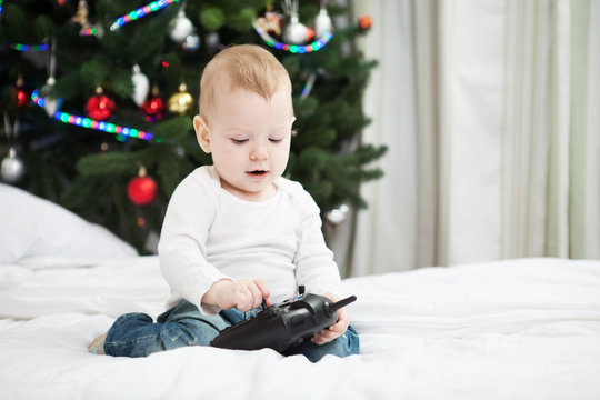 Toddler boy holding RC controller at christmas time