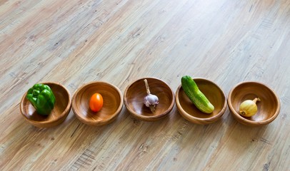 Fresh vegetables in wooden bowls row