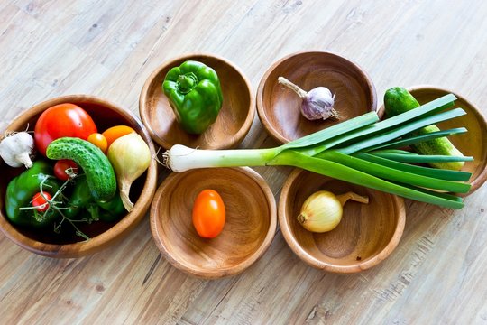 Fresh vegetables in wooden bowls