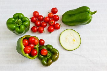 Small tomatoes in cut green pepper with zucchini slice