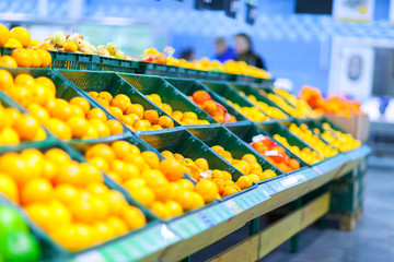 Many oranges on counter in the store