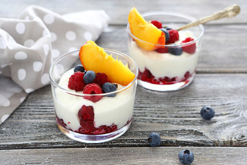 yogurt with fresh berries and peaches - obrazy, fototapety, plakaty