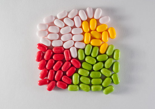 multicolored pills, candy on white background
