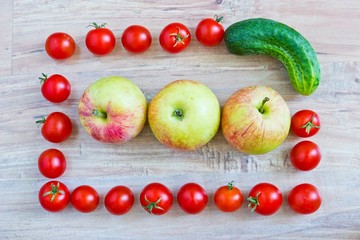 Fresh vegetable frame with apples: tomatoes and cucumber