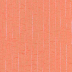 coral color textile background from stitched silk